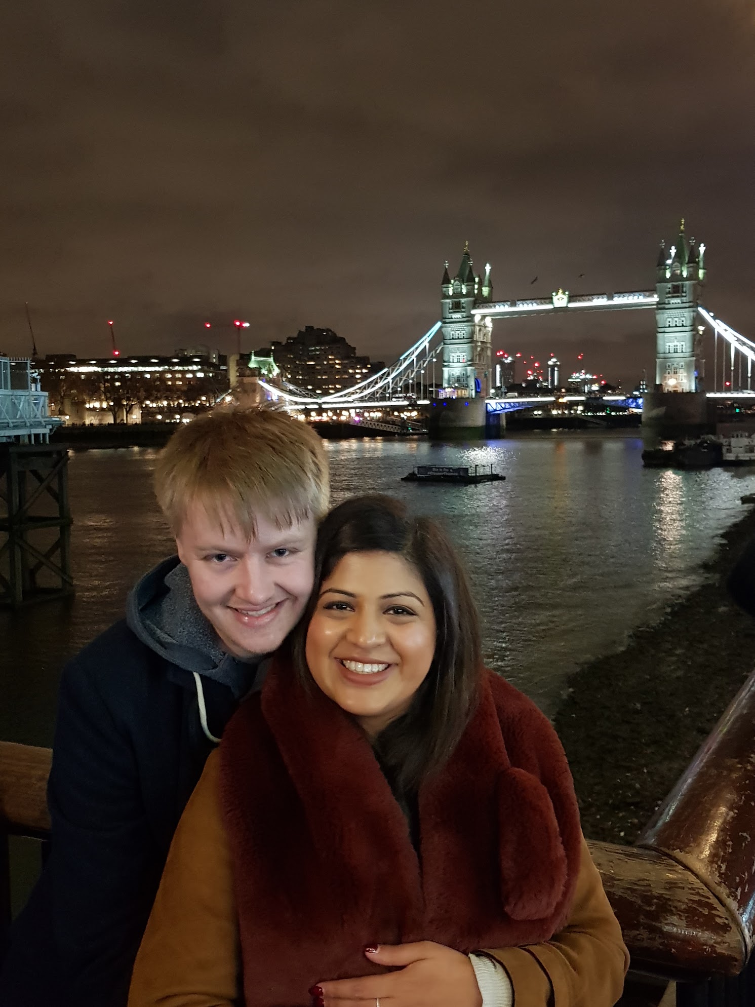Sandy and Darsh in front of Tower Bridge in London
